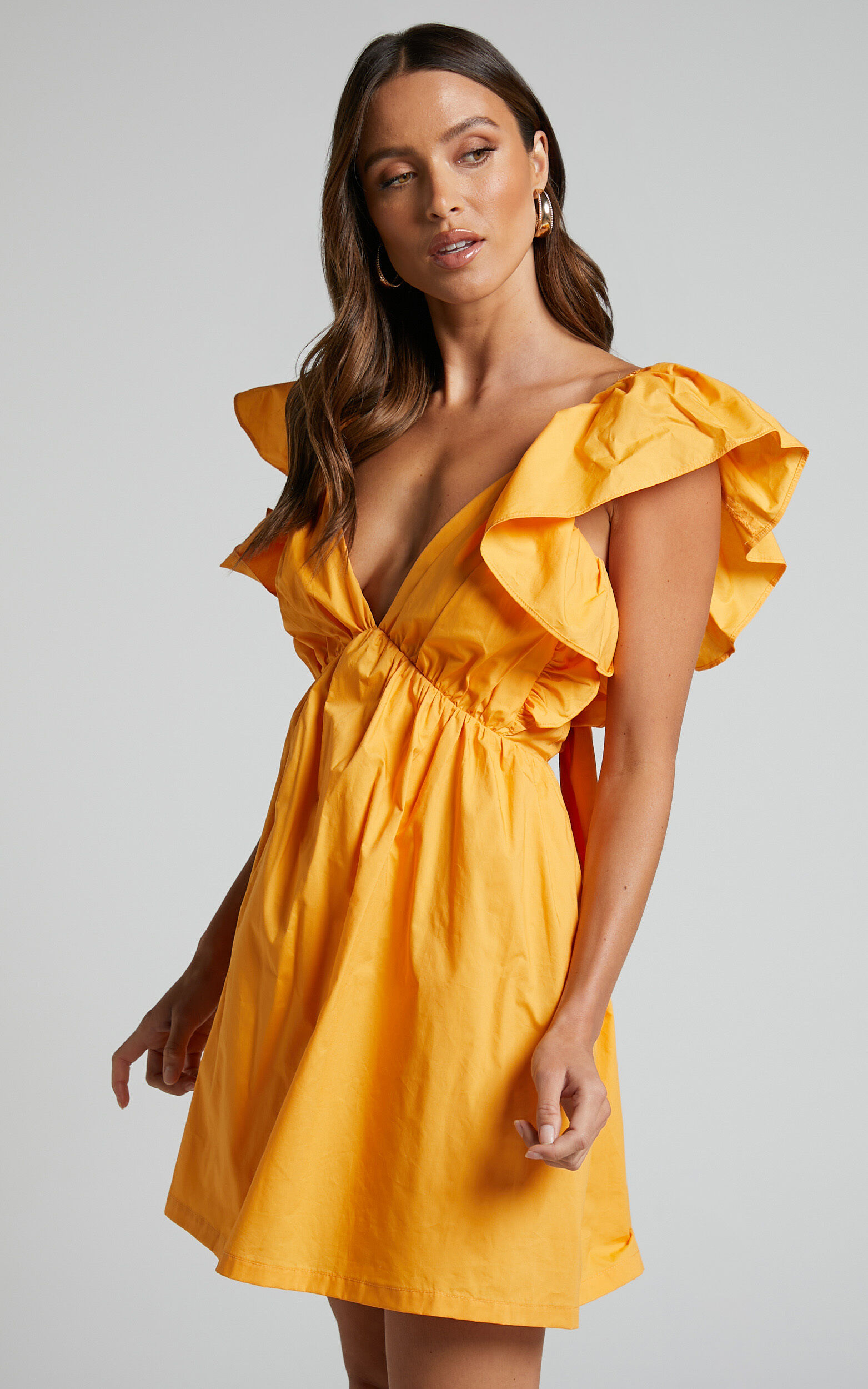 Raiza Mini Dress Ruffle Sleeve Tie Back Plunge Dress in Marigold Showpo