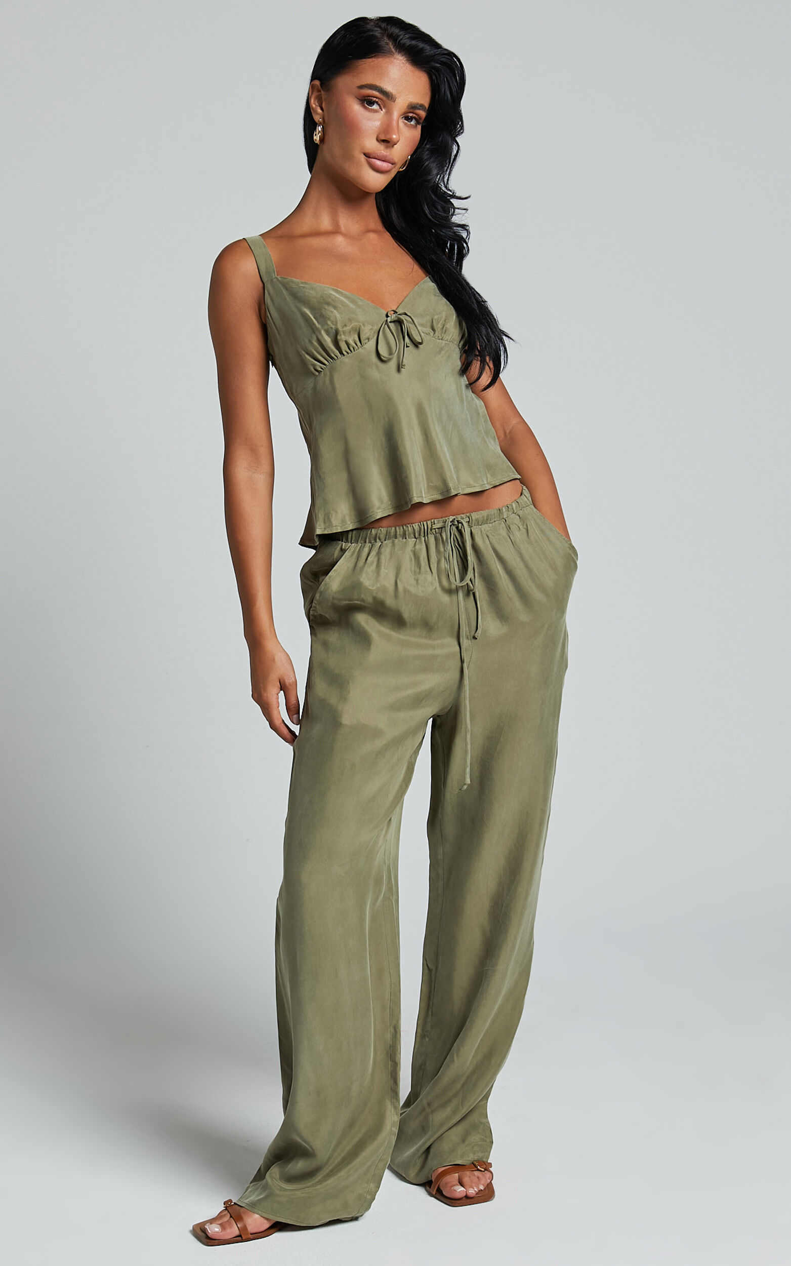 https://images.showpo.com/dw/image/v2/BDPQ_PRD/on/demandware.static/-/Sites-sp-master-catalog/default/dw4b564059/images/chaya-pants-cupro-mid-waisted-drawstring-pants-SB24010013/Chaya_Pants_-_Cupro_Mid_Waisted_Drawstring_Pants_in_Moss__1.JPG?sw=1563&sh=2500