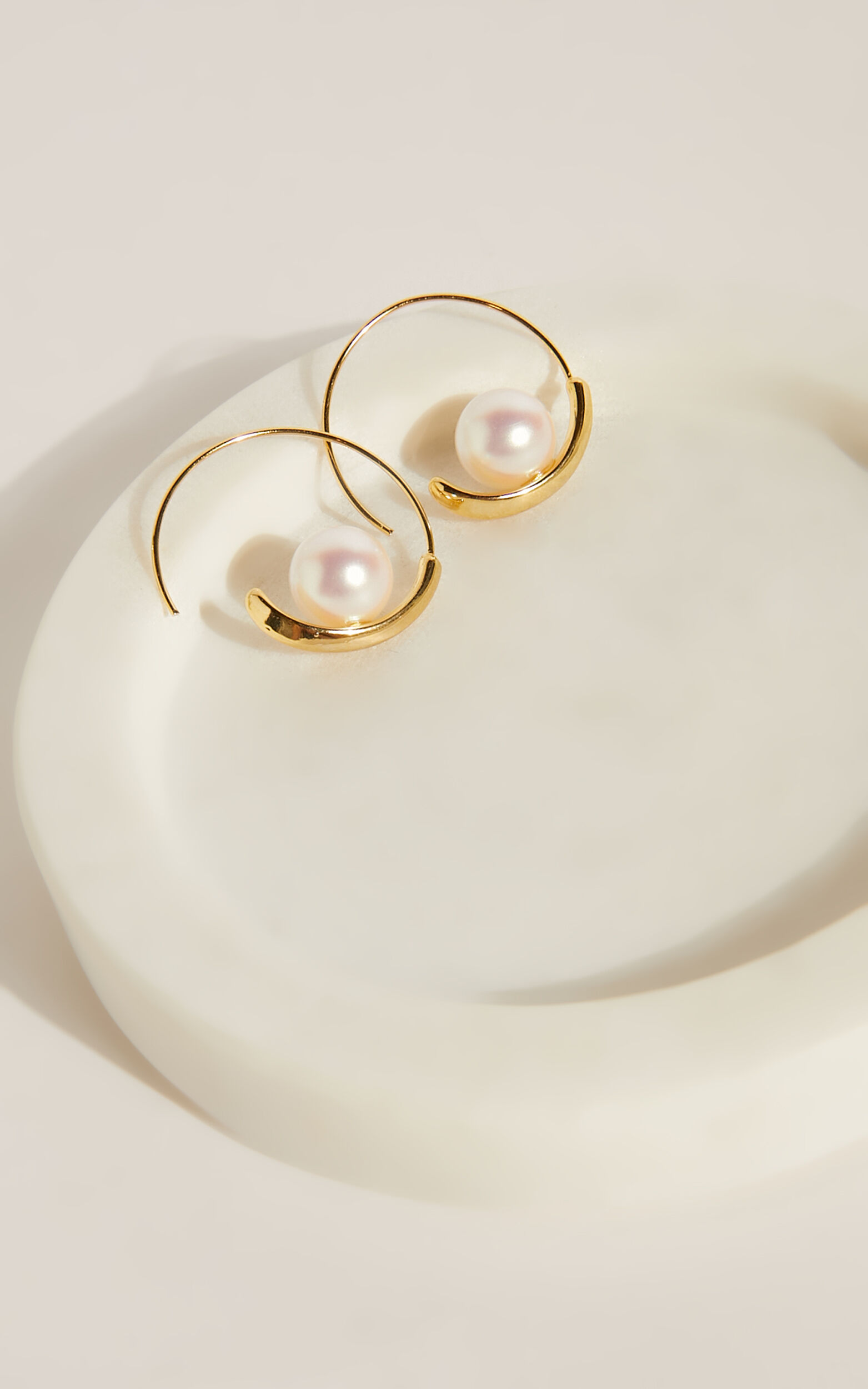 Floating pearl top hoop earrings