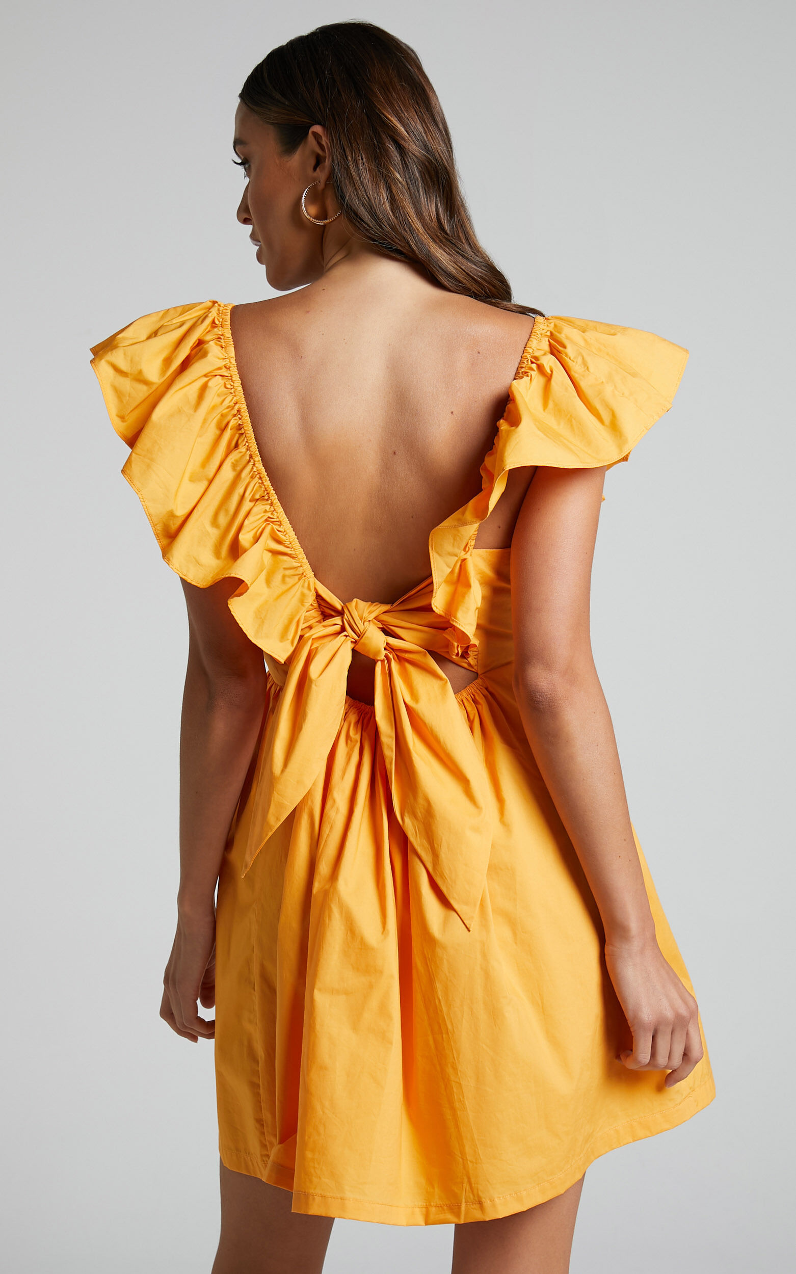 Raiza Mini Dress Ruffle Sleeve Tie Back Plunge Dress in Marigold